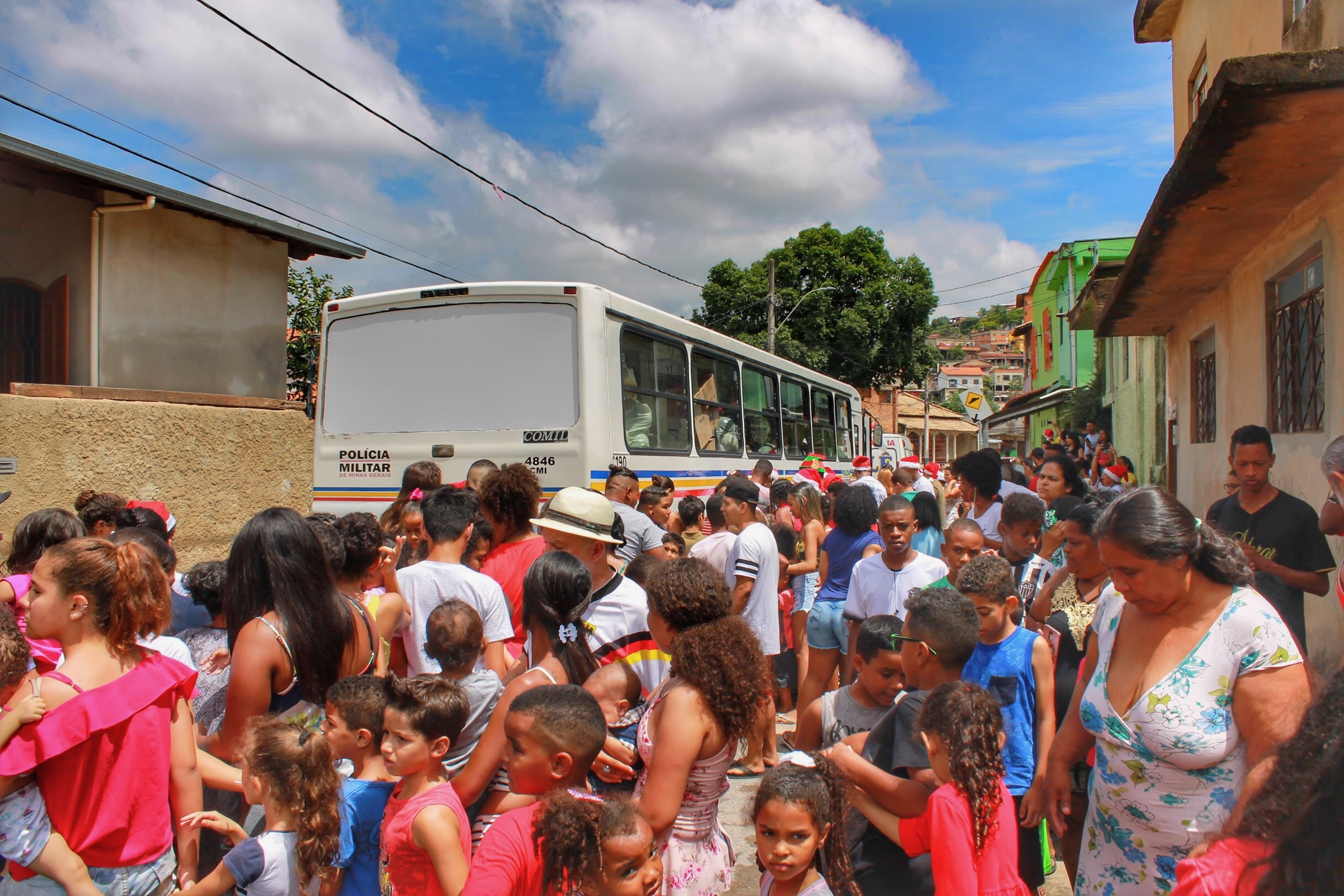 Families lining the street as the motorcade bus arrives