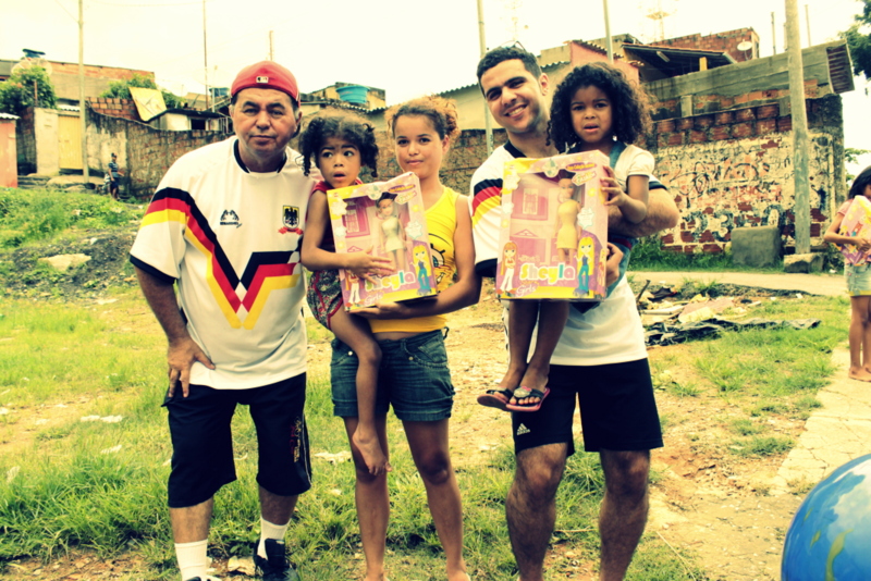 Heleno Doria and Philippe with three girls holding new boxed dolls