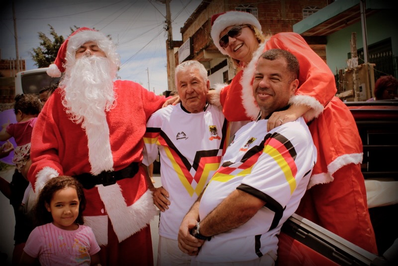 Santa and volunteers with a young child during the Christmas motorcade