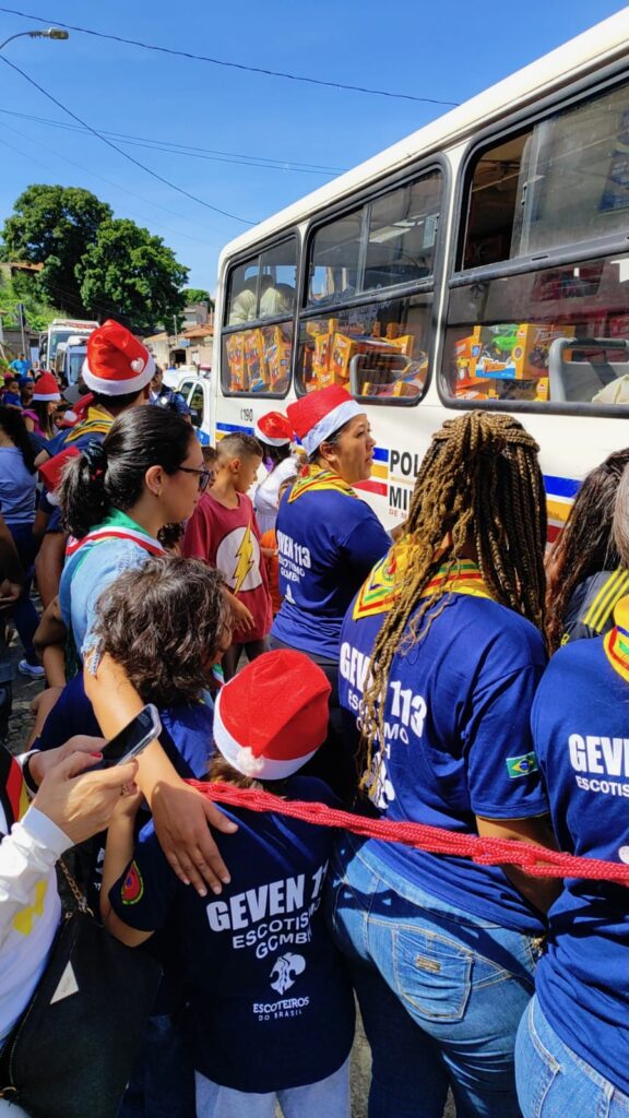 Volunteers in Santa hats gathered at a motorcade stop