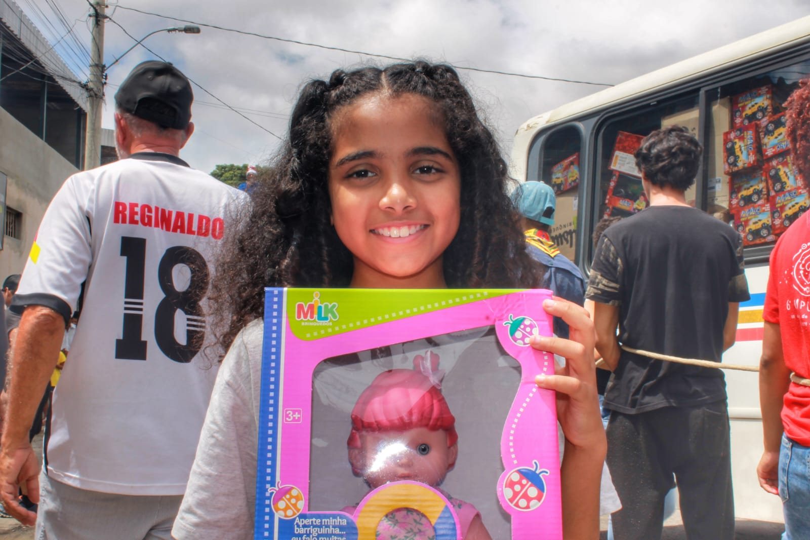 A girl smiling with her new doll, 2022